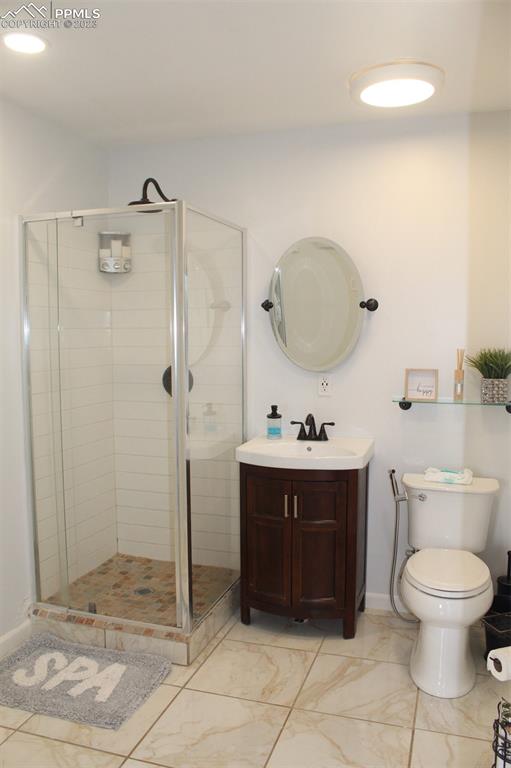425 Weissenfluh Road Yoder, CO 80864 - Photo 21 of 38 a bathroom with a toilet a sink and shower