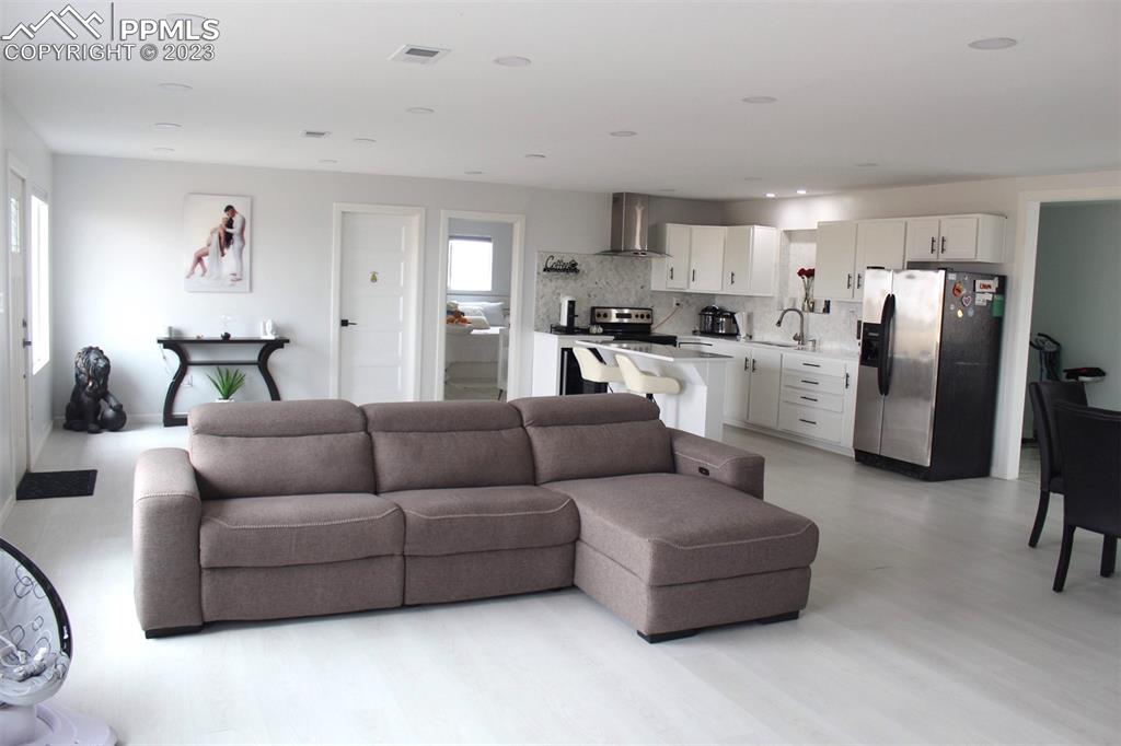 425 Weissenfluh Road Yoder, CO 80864 - Photo 22 of 38 a living room with furniture and kitchen view
