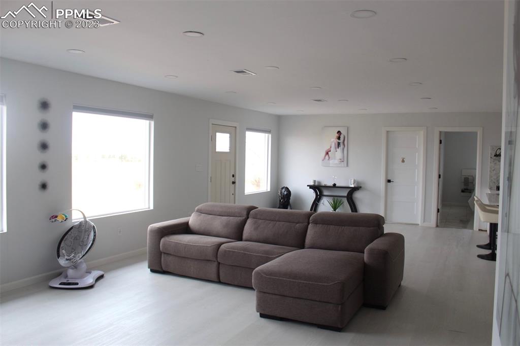 425 Weissenfluh Road Yoder, CO 80864 - Photo 24 of 38 a living room with furniture a window and gym equipment