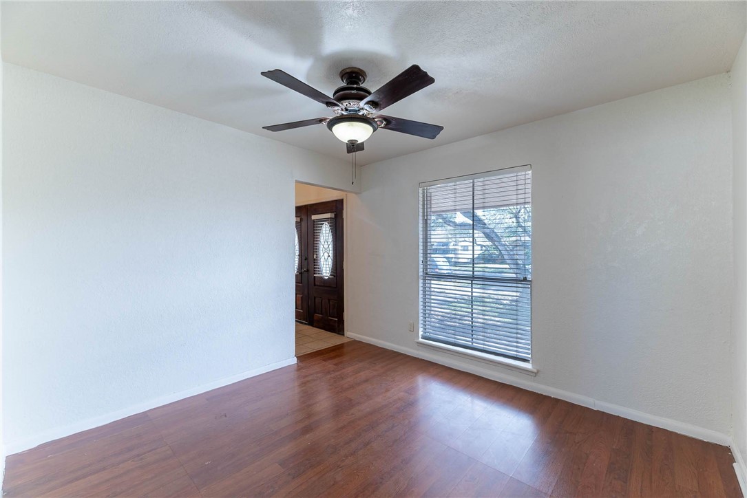 4622 Coventry Lane Corpus Christi, TX 78411 - Photo 11 of 31 an empty room with wooden floor fan and windows