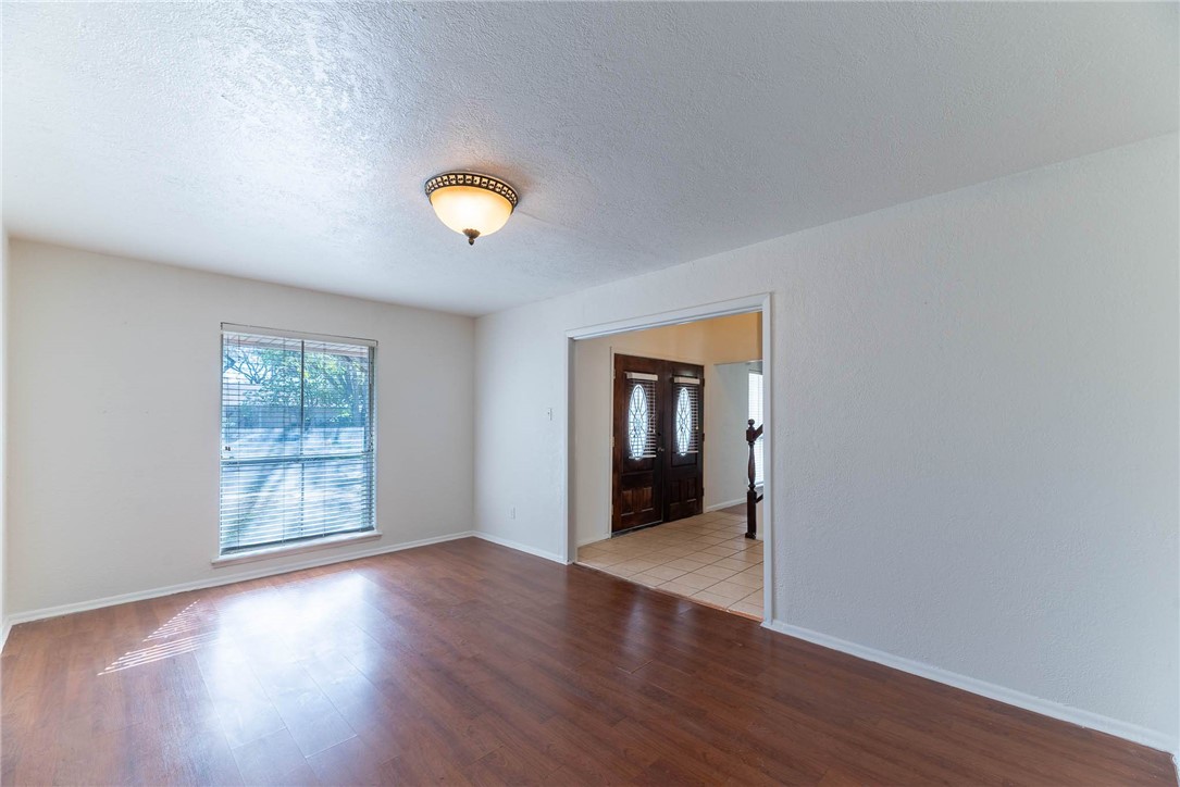 4622 Coventry Lane Corpus Christi, TX 78411 - Photo 12 of 31 a view of an empty room with window and wooden floor