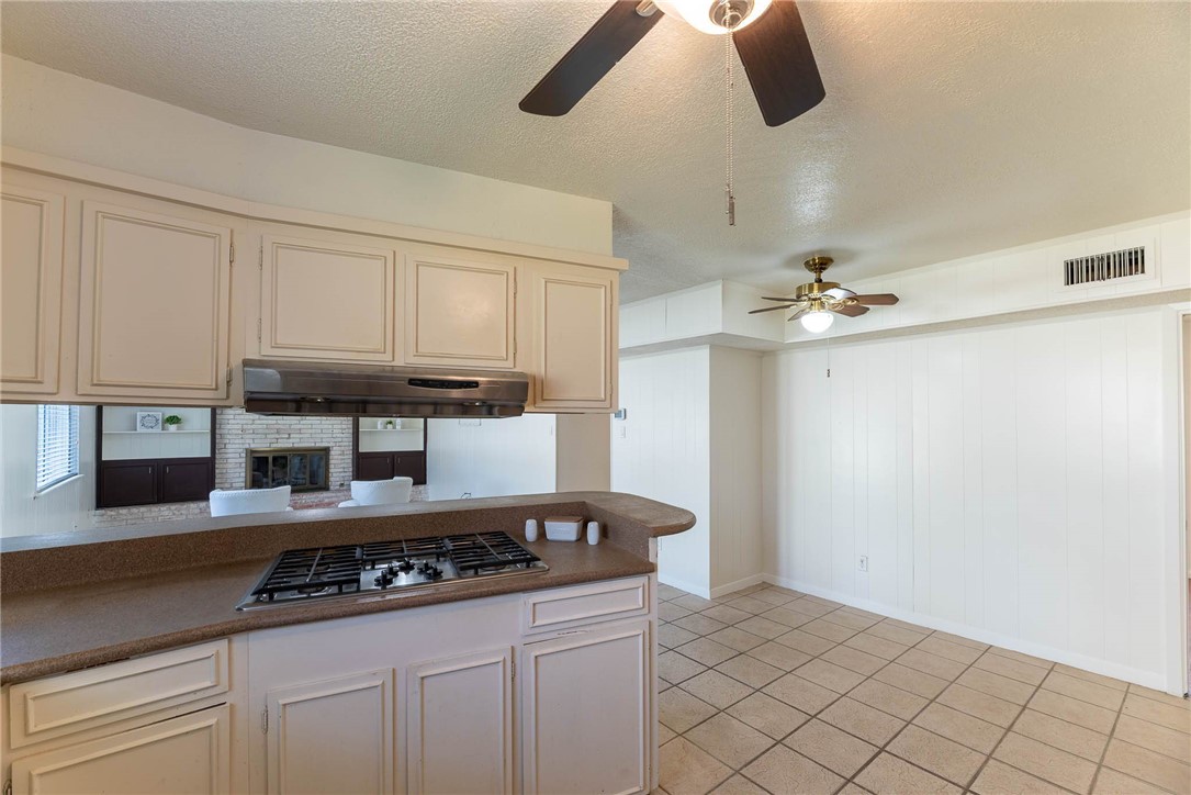4622 Coventry Lane Corpus Christi, TX 78411 - Photo 16 of 31 a kitchen with a stove and white cabinets
