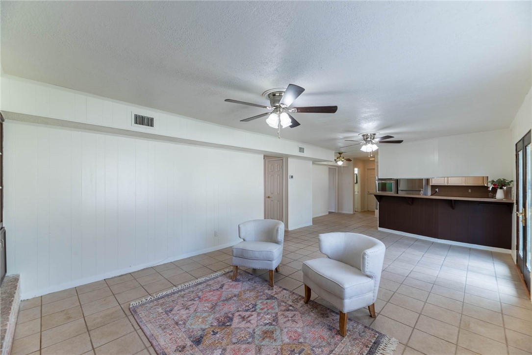 4622 Coventry Lane Corpus Christi, TX 78411 - Photo 20 of 31 a living room with furniture and a chandelier