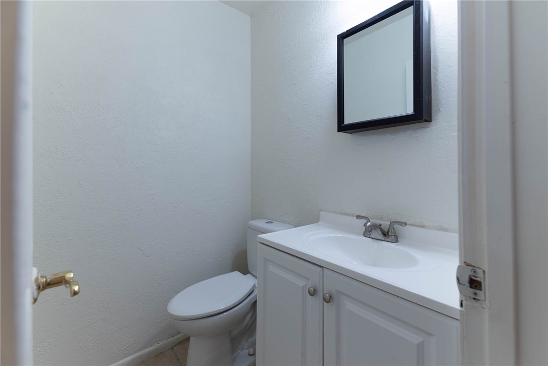 4622 Coventry Lane Corpus Christi, TX 78411 - Photo 21 of 31 a bathroom with a toilet sink and mirror