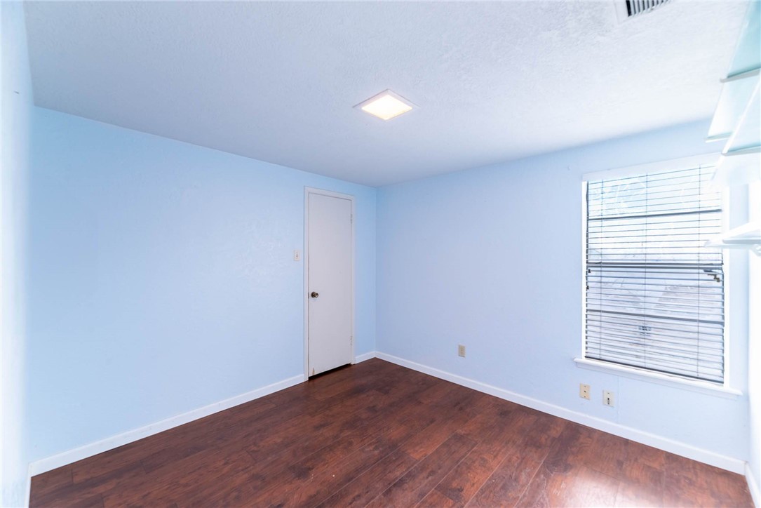 4622 Coventry Lane Corpus Christi, TX 78411 - Photo 22 of 31 a view of an empty room with wooden floor and a window