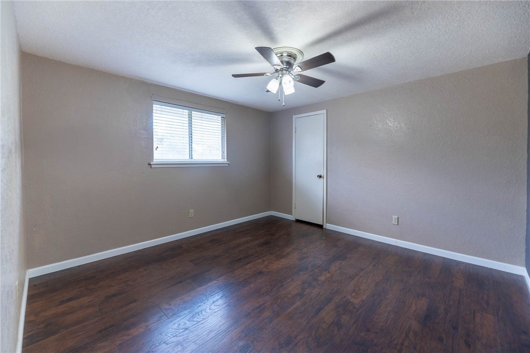 4622 Coventry Lane Corpus Christi, TX 78411 - Photo 23 of 31 a view of an empty room with wooden floor and a window
