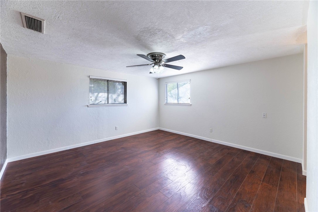 4622 Coventry Lane Corpus Christi, TX 78411 - Photo 24 of 31 a view of an empty room with wooden floor and a window