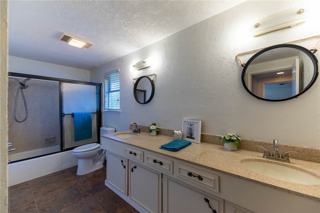 4622 Coventry Lane Corpus Christi, TX 78411 - Photo 29 of 31 a bathroom with a granite countertop double vanity and a mirror