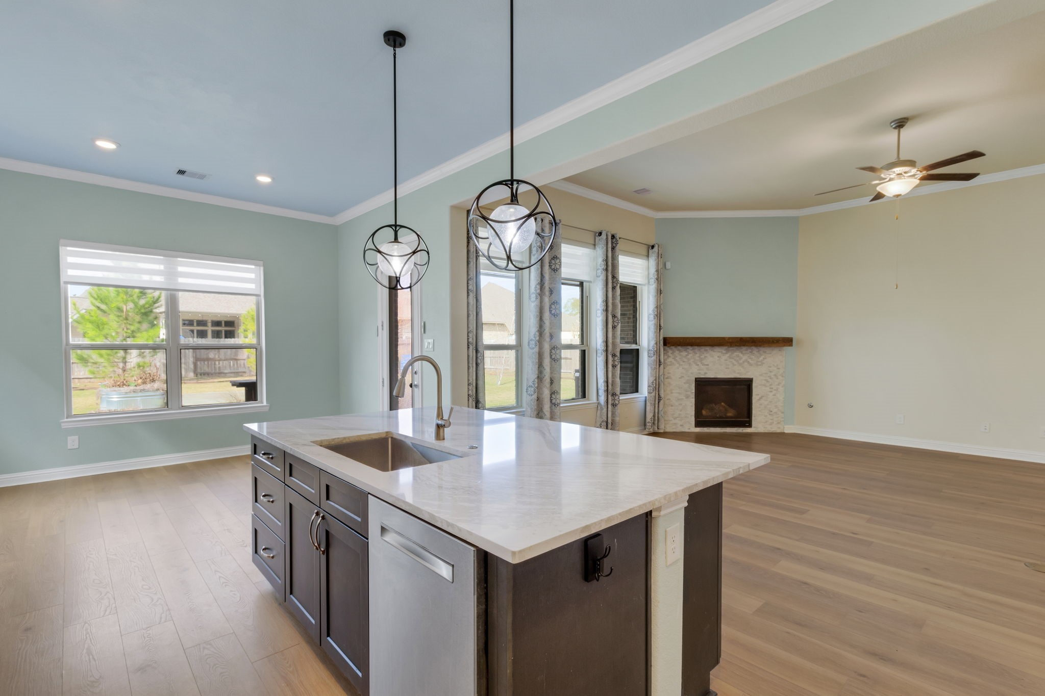 23509 Red Juniper Lane New Caney, TX 77357 - Photo 11 of 48 a kitchen with a center island wooden floor appliances and a chandelier