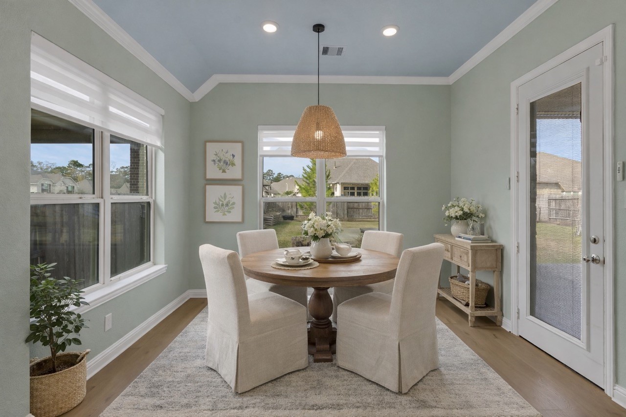 23509 Red Juniper Lane New Caney, TX 77357 - Photo 15 of 48 a dining room with furniture a potted plant and a chandelier