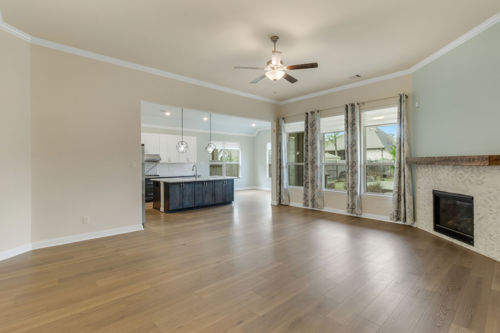 23509 Red Juniper Lane New Caney, TX 77357 - Photo 7 of 48 a view of an empty room with wooden floor and a fireplace