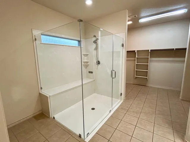 a bathroom with a shower and a mirror