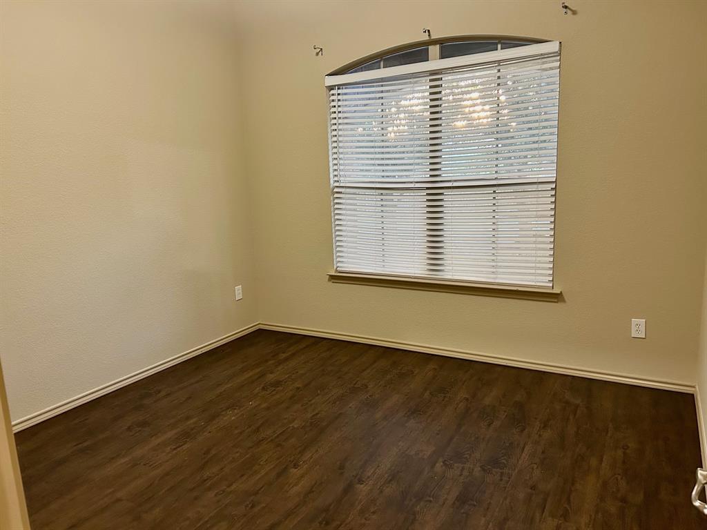 3105 Pecan Tree Drive Denton, TX 76210 - Photo 19 of 25 Empty room with dark wood finished floors