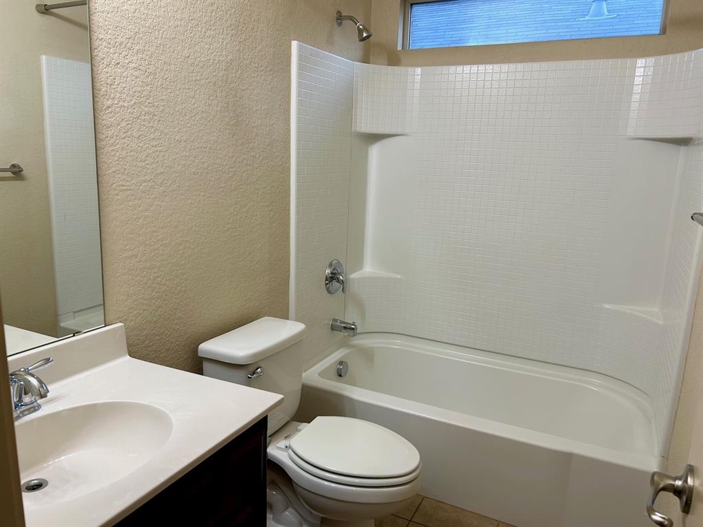 3105 Pecan Tree Drive Denton, TX 76210 - Photo 21 of 25 Full bath with a textured wall, vanity, bathtub / shower combination, and tile patterned flooring