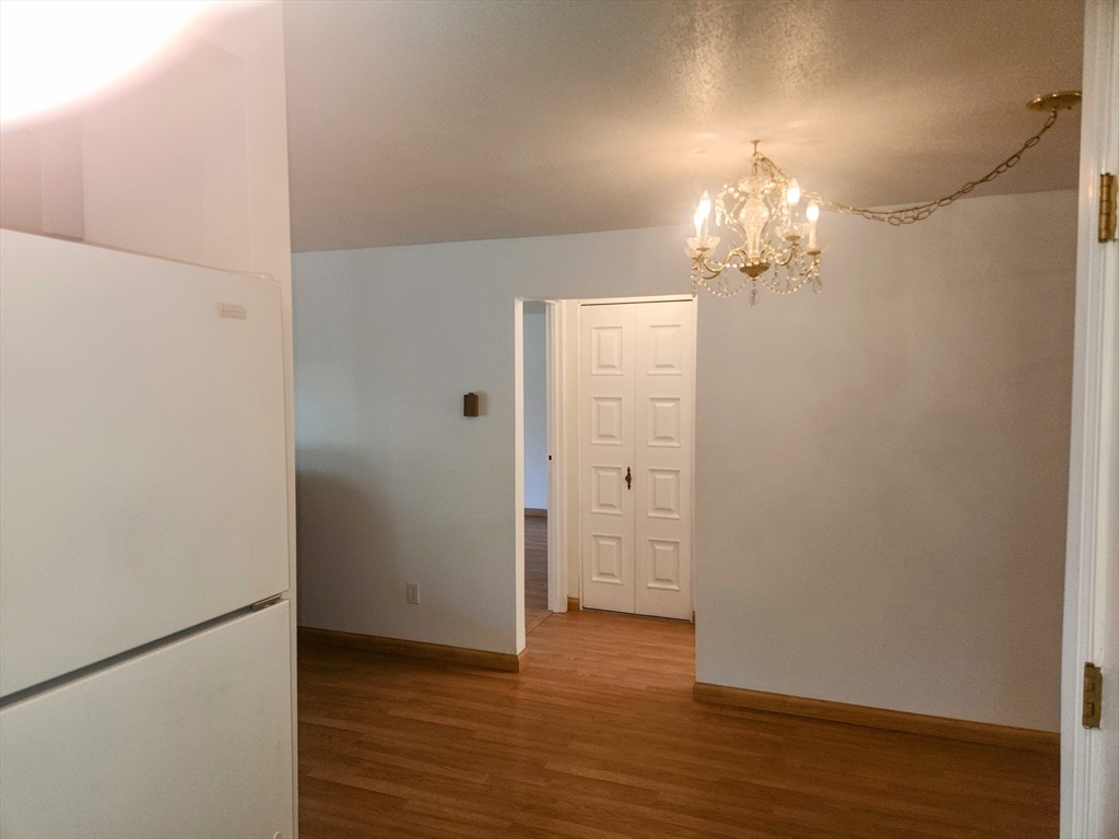 1003 North Main Street, Unit 7 Randolph, MA 02368 - Photo 15 of 31 an empty room with wooden floor