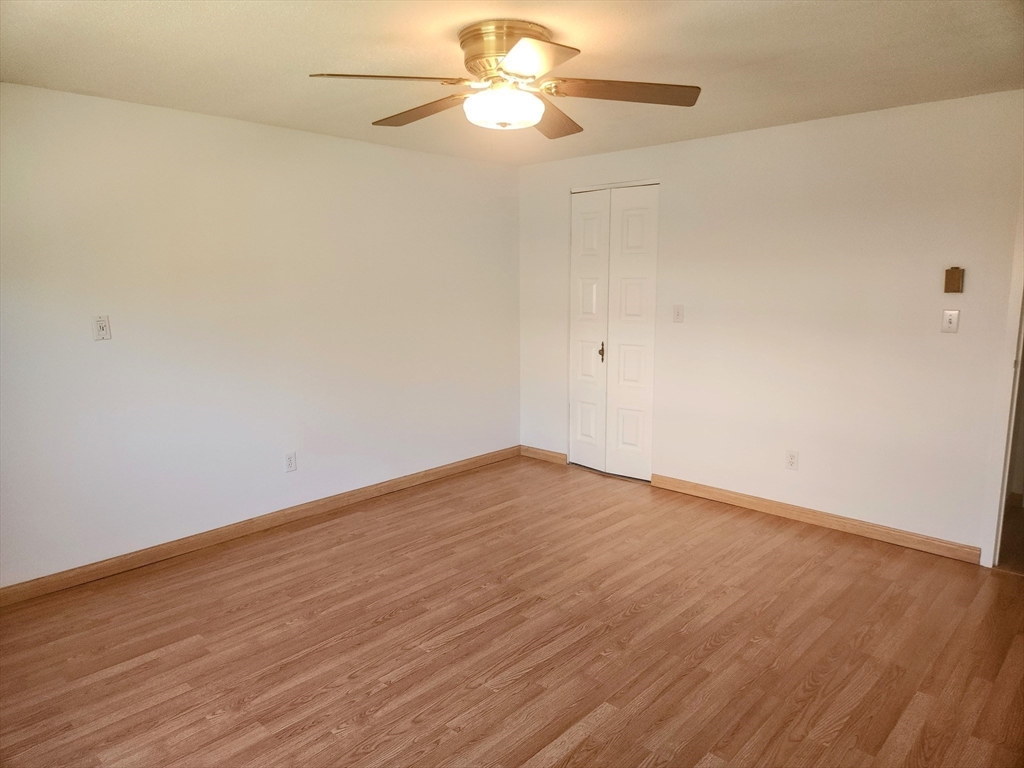1003 North Main Street, Unit 7 Randolph, MA 02368 - Photo 18 of 31 a view of an empty room with wooden floor