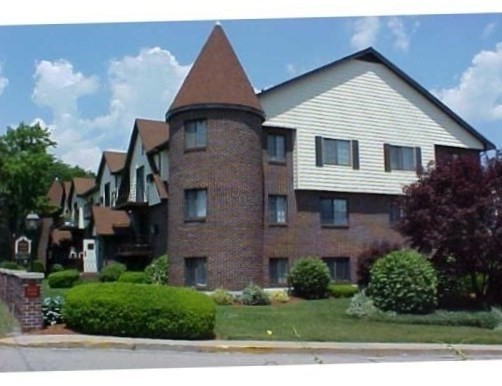1003 North Main Street, Unit 7 Randolph, MA 02368 - Photo 2 of 31 a front view of a house with a yard