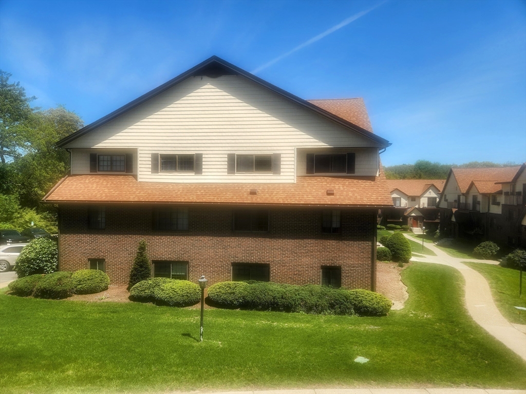1003 North Main Street, Unit 7 Randolph, MA 02368 - Photo 21 of 31 a front view of house with yard and green space