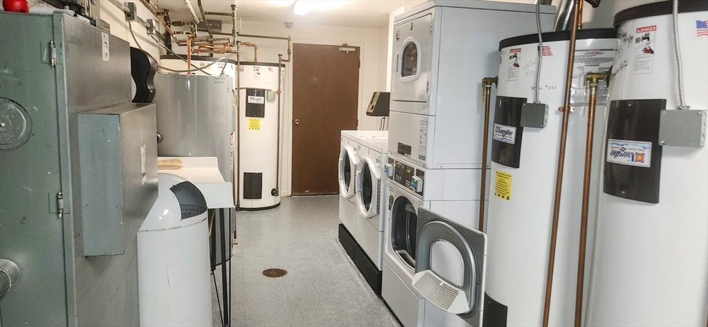 1003 North Main Street, Unit 7 Randolph, MA 02368 - Photo 23 of 31 a view of walk in closet with clothes and shoes