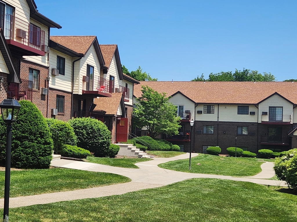 1003 North Main Street, Unit 7 Randolph, MA 02368 - Photo 29 of 31 a view of a big house with a big yard and potted plants