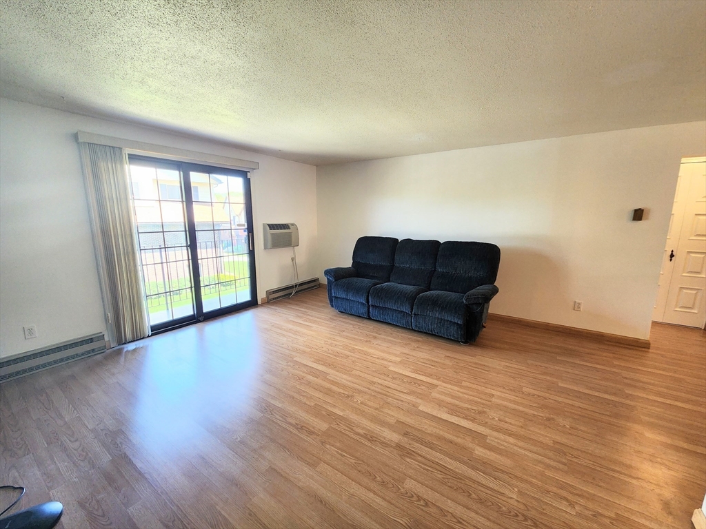 1003 North Main Street, Unit 7 Randolph, MA 02368 - Photo 5 of 31 a living room with hard wood floors and furniture