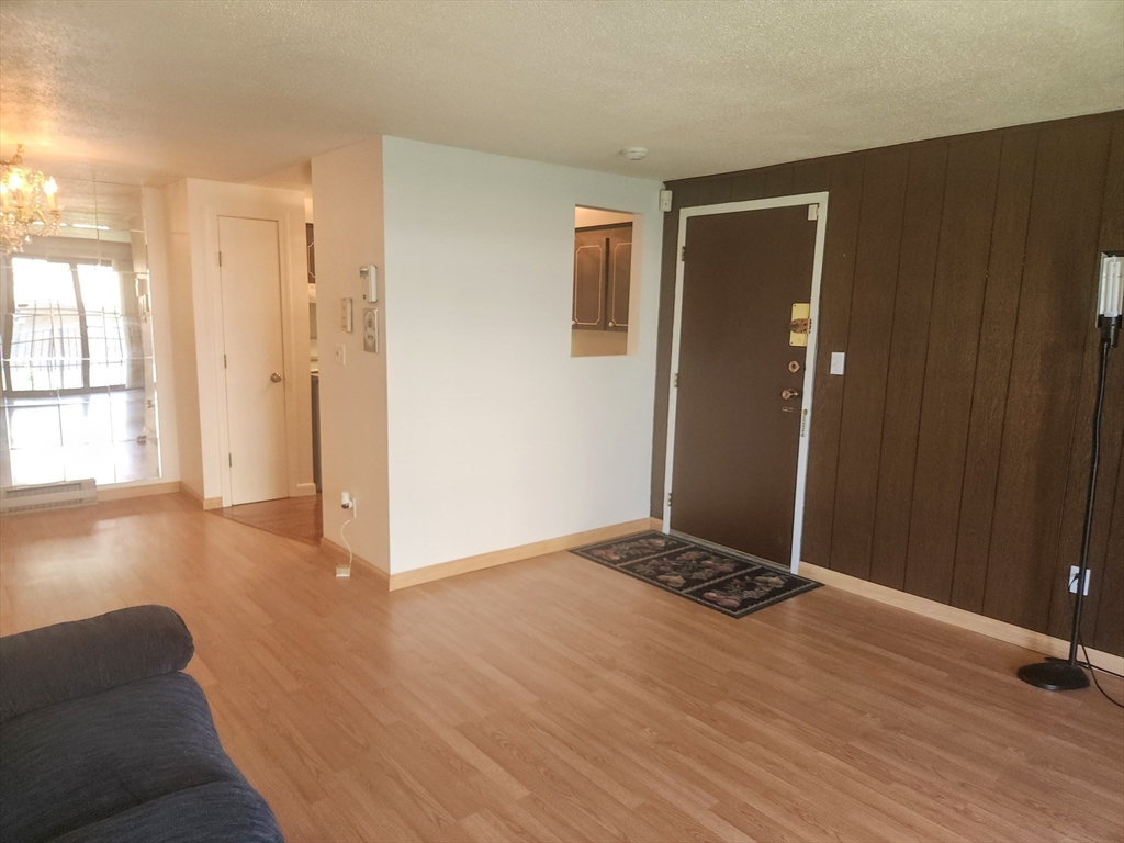 1003 North Main Street, Unit 7 Randolph, MA 02368 - Photo 8 of 31 a view of livingroom with hardwood floor and window