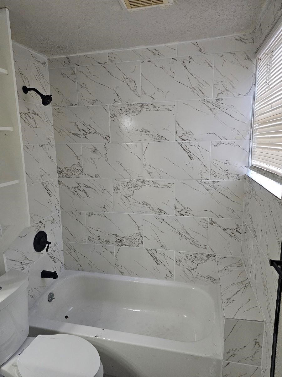 8010 Miley Street Houston, TX 77028 - Photo 6 of 8 a bathroom with a toilet and a bathtub