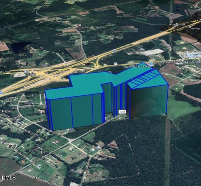 378 Rozier Church Road Lumberton, NC 28360 - Photo 6 of 10 a backyard of a house with table and chairs under an umbrella