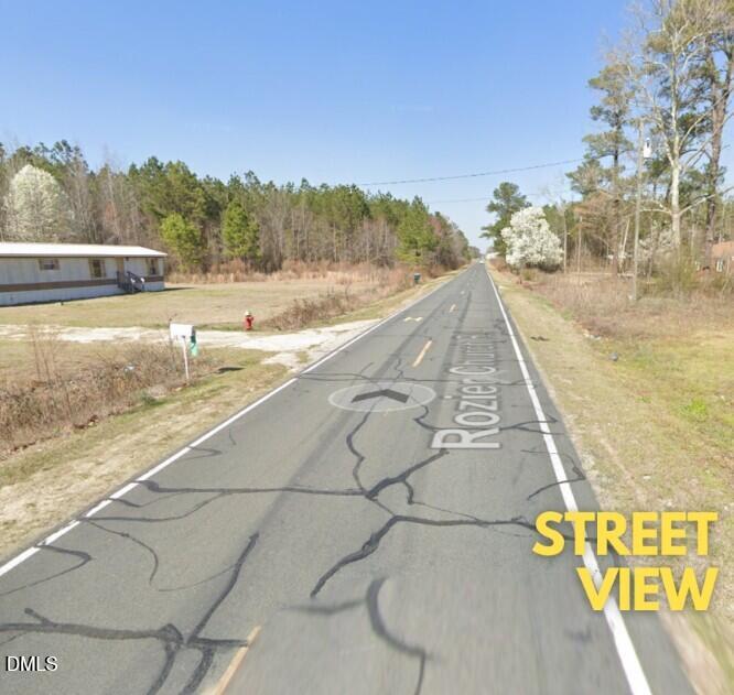 378 Rozier Church Road Lumberton, NC 28360 - Photo 7 of 10 a view of a swimming pool with a yard