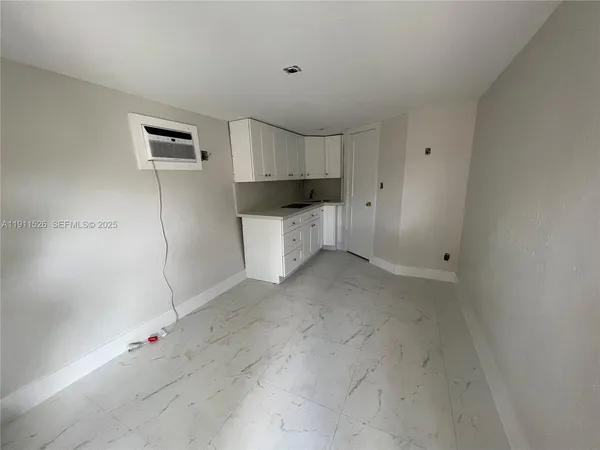 a view of kitchen with white cabinets