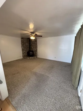 a view of an empty room with a fireplace