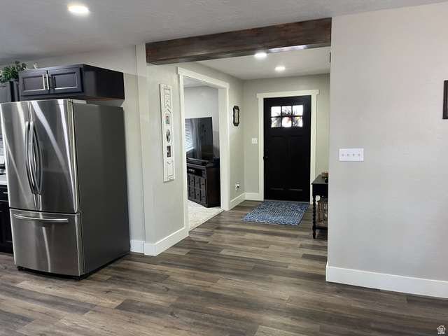 558 North N Cres Road Roosevelt, UT 84066 - Photo 26 of 31 Entryway featuring a dark wood door with glass inserts, wood-finish flooring, and a decorative exposed beam