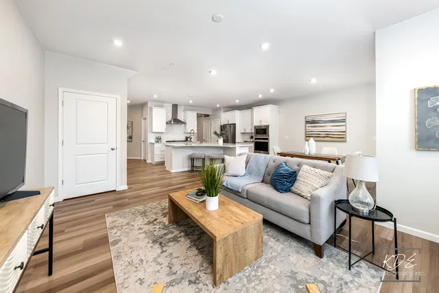 a living room with stainless steel appliances furniture or couch and a kitchen