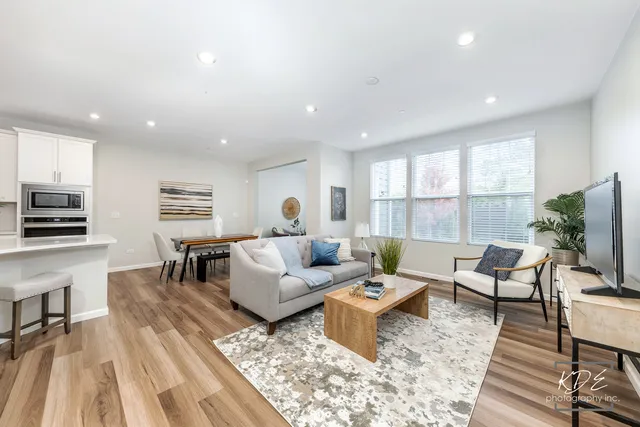 a living room with furniture wooden floor and a flat screen tv