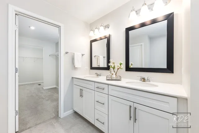 a bathroom with a double vanity sink and mirror
