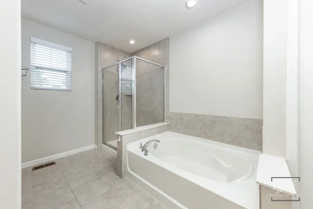 a bathroom with a bathtub and a shower