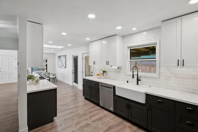 a large kitchen with a sink and cabinets
