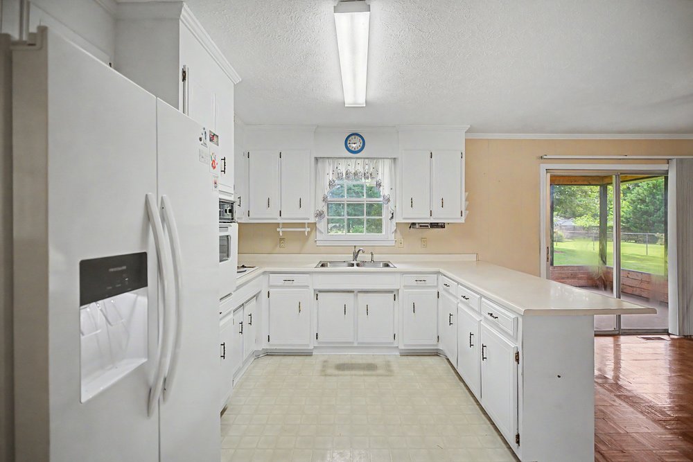 115 Brunson Drive Pickens, SC 29671 - Photo 6 of 29 A well-lit kitchen with ample cabinet space, offering a functional layout for daily routines.