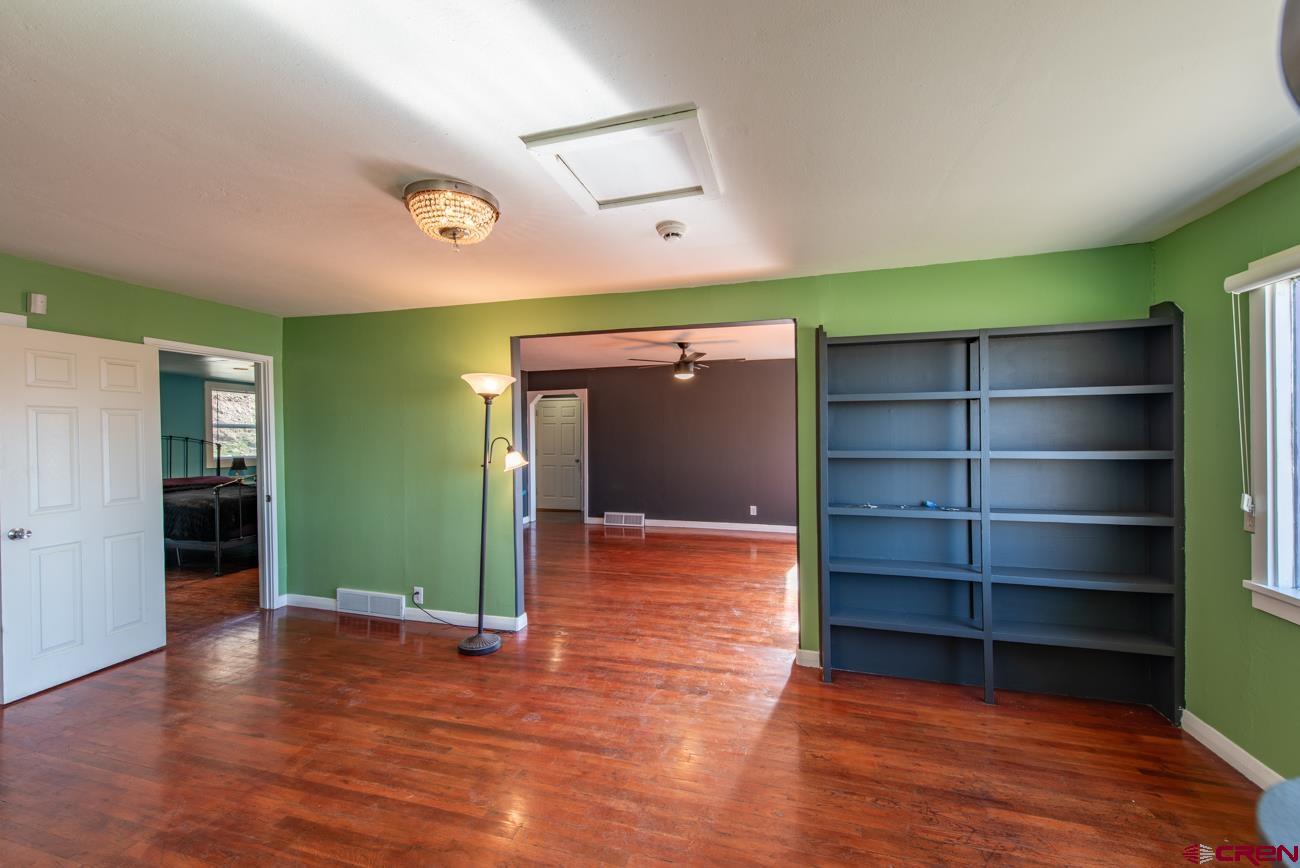 16322 Chipeta Road Montrose, CO 81403 - Photo 12 of 42 a view of room with window and wooden floor