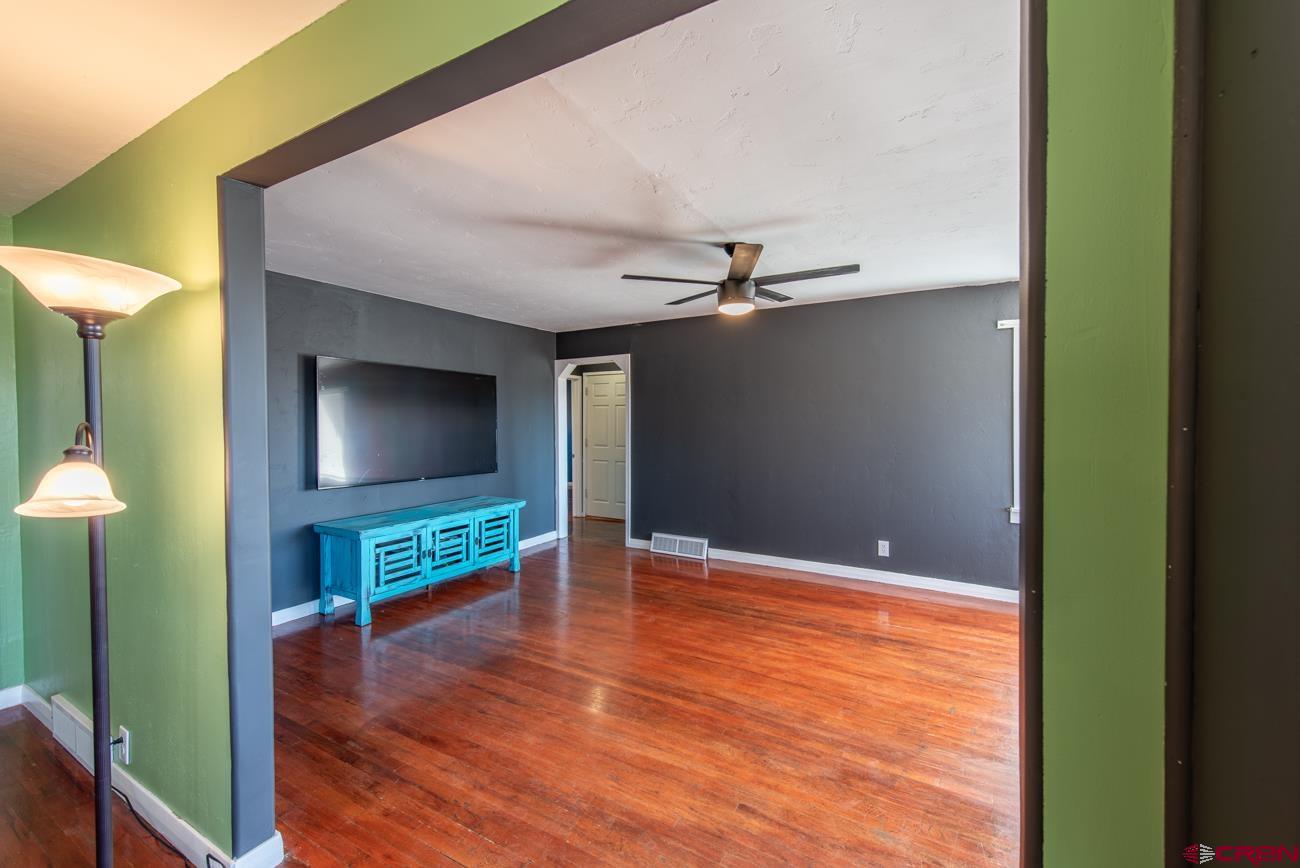 16322 Chipeta Road Montrose, CO 81403 - Photo 17 of 42 a living room with furniture and a flat screen tv