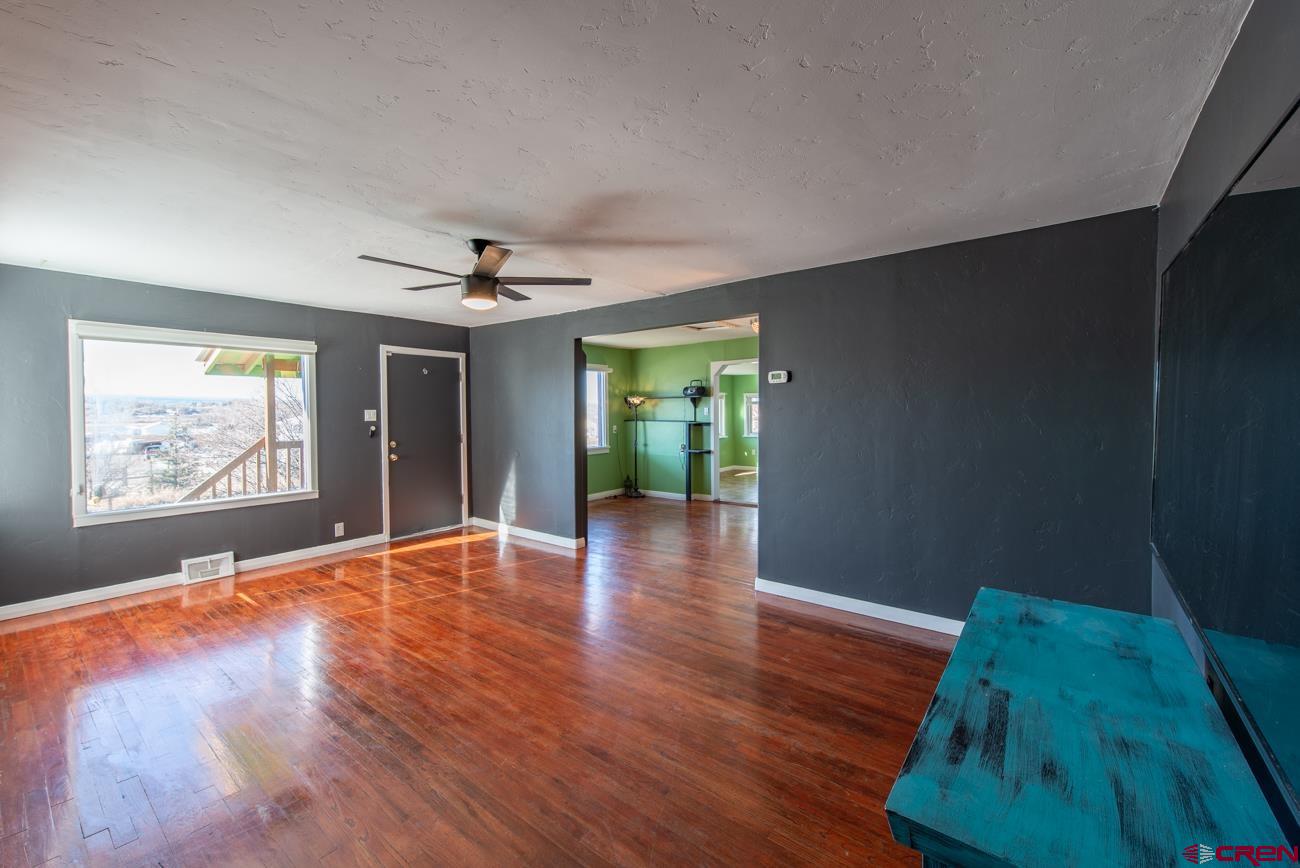 16322 Chipeta Road Montrose, CO 81403 - Photo 18 of 42 a view of livingroom with window and wooden floor