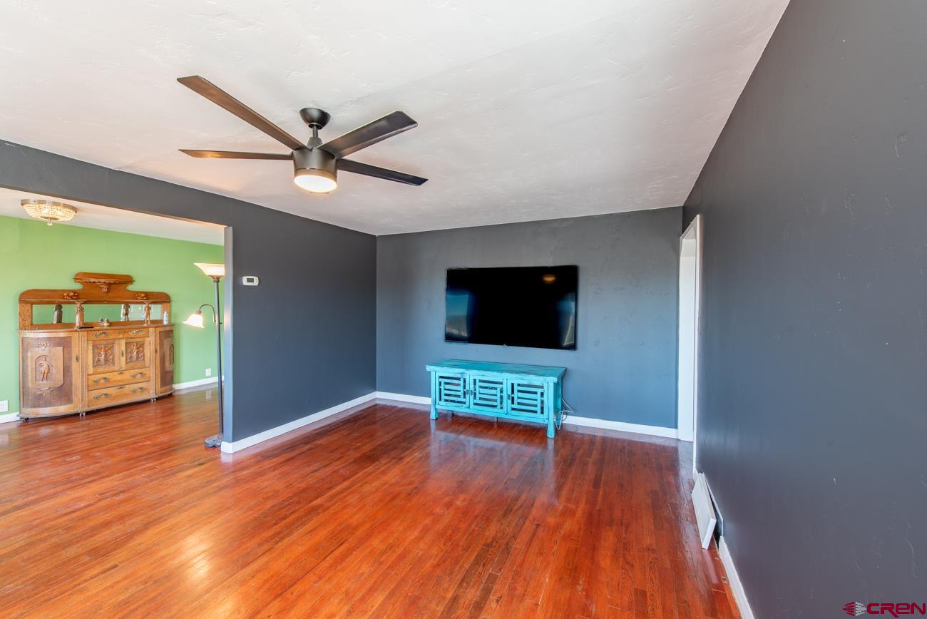 16322 Chipeta Road Montrose, CO 81403 - Photo 19 of 42 a living room with furniture and a flat screen tv