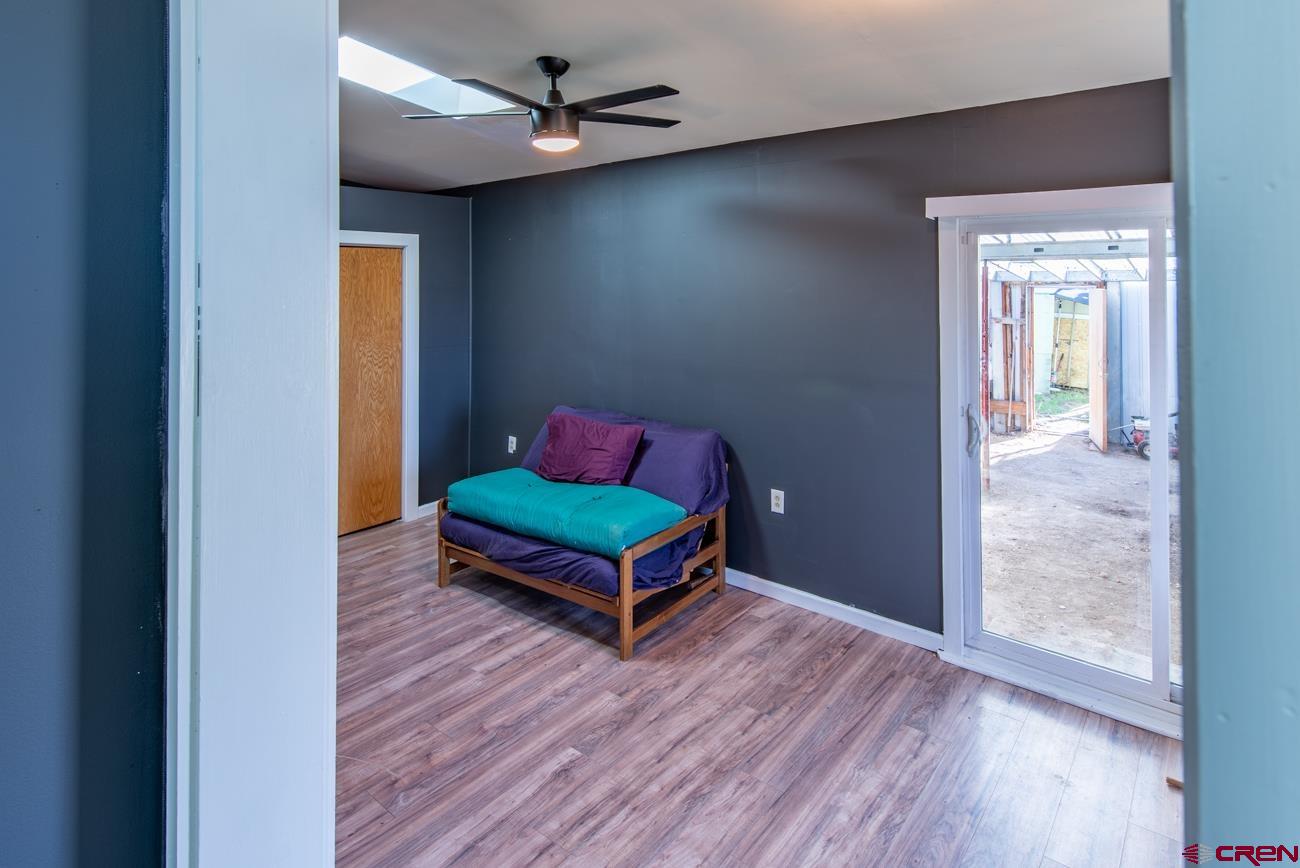 16322 Chipeta Road Montrose, CO 81403 - Photo 26 of 42 a room with furniture and wooden floor