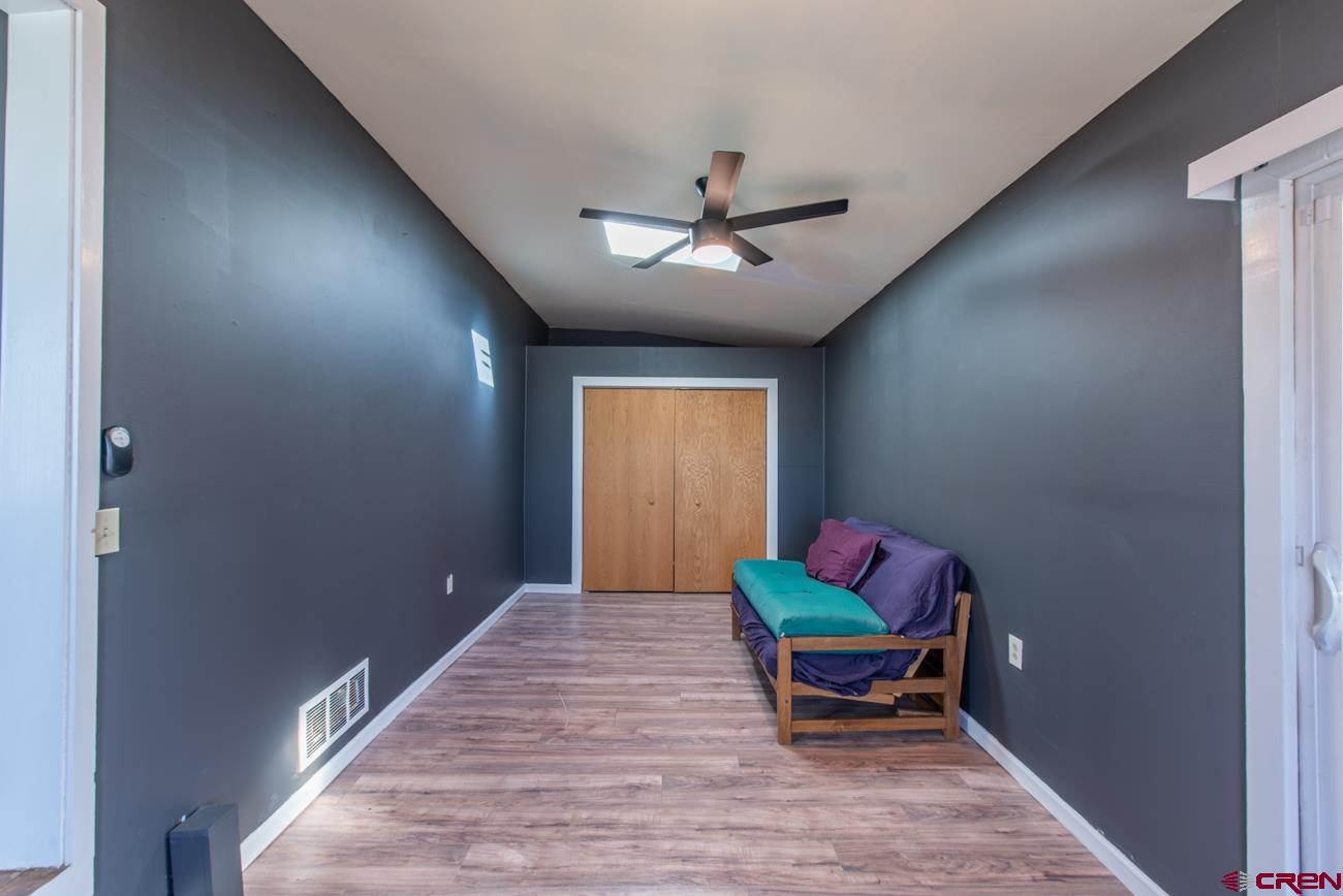 16322 Chipeta Road Montrose, CO 81403 - Photo 27 of 42 a living room with furniture and a ceiling fan