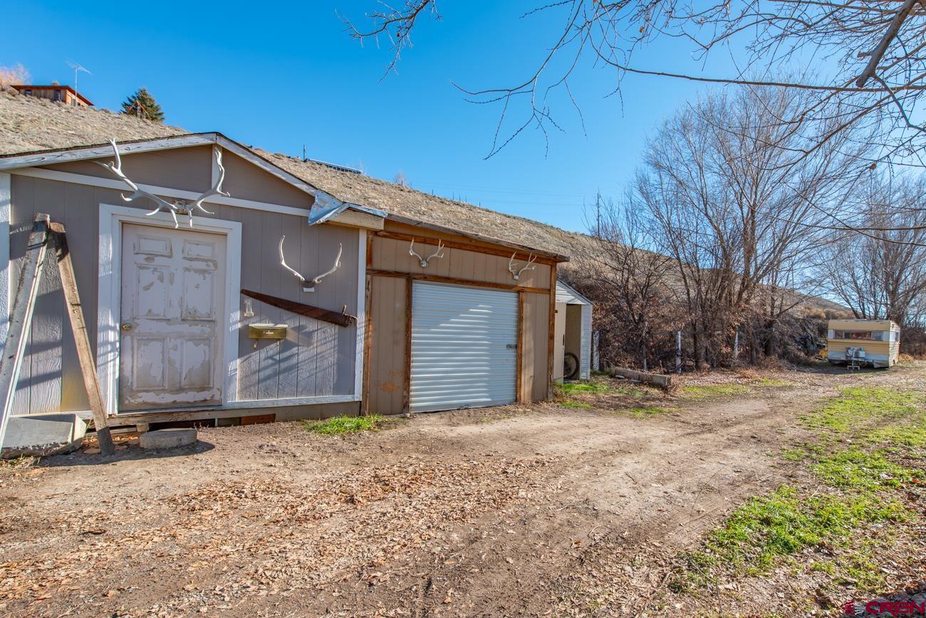 16322 Chipeta Road Montrose, CO 81403 - Photo 5 of 42 a front view of a house with a yard