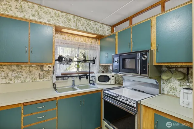 a kitchen with stainless steel appliances a refrigerator sink and cabinets