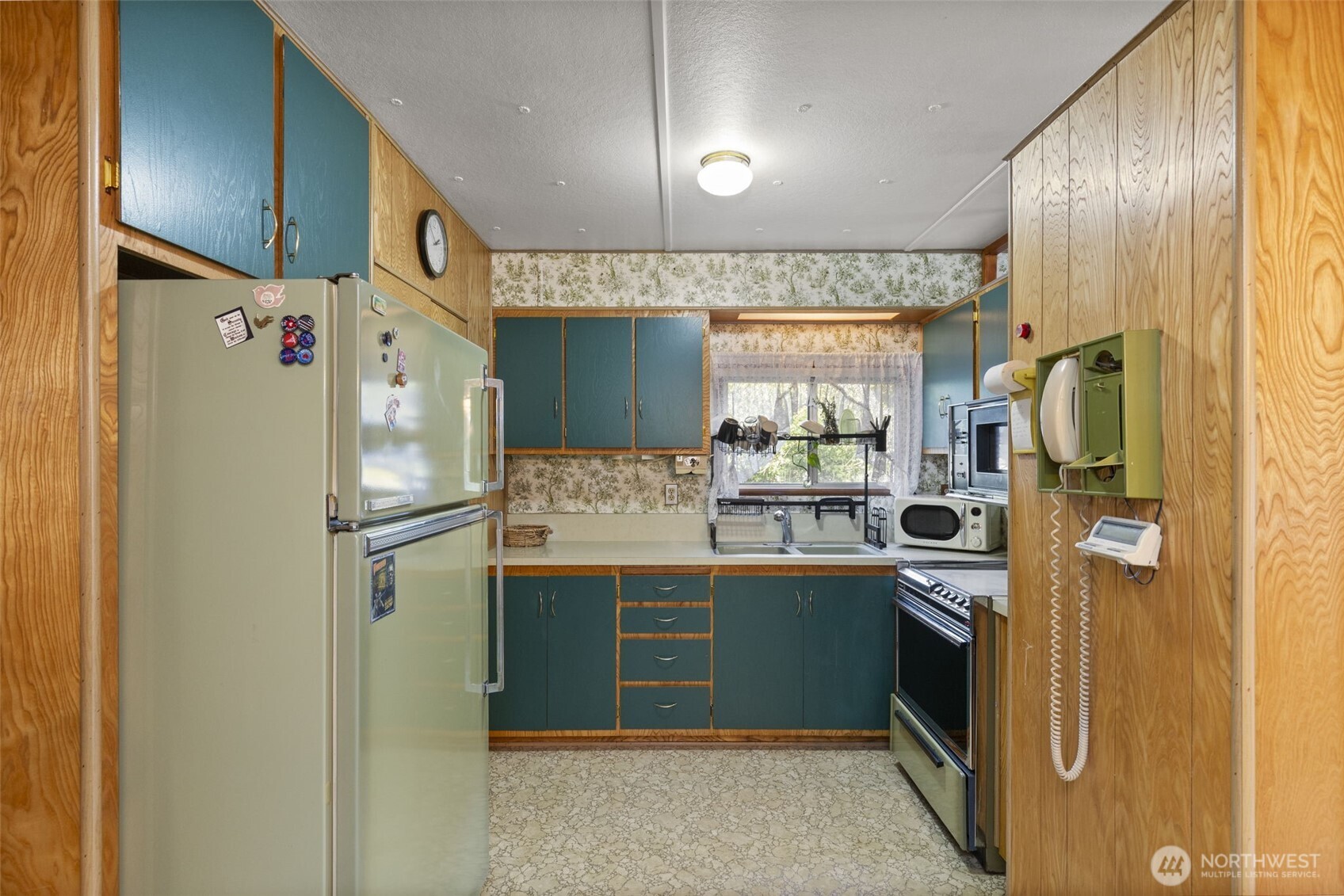 8491 Illahee Road Northeast Bremerton, WA 98311 - Photo 17 of 36 a kitchen with stainless steel appliances a refrigerator sink and cabinets