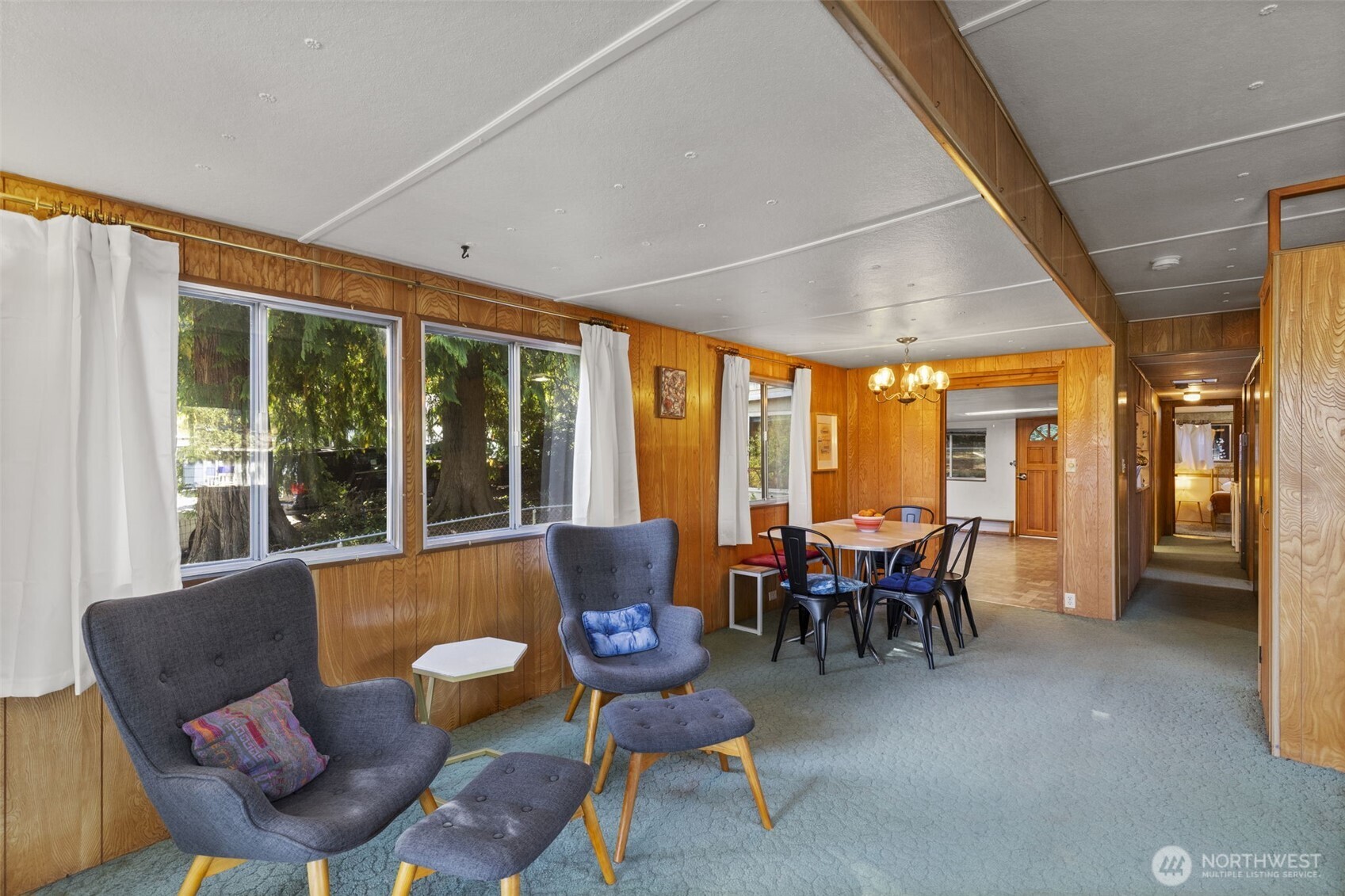 8491 Illahee Road Northeast Bremerton, WA 98311 - Photo 23 of 36 a dining room with furniture water view and a floor to ceiling window