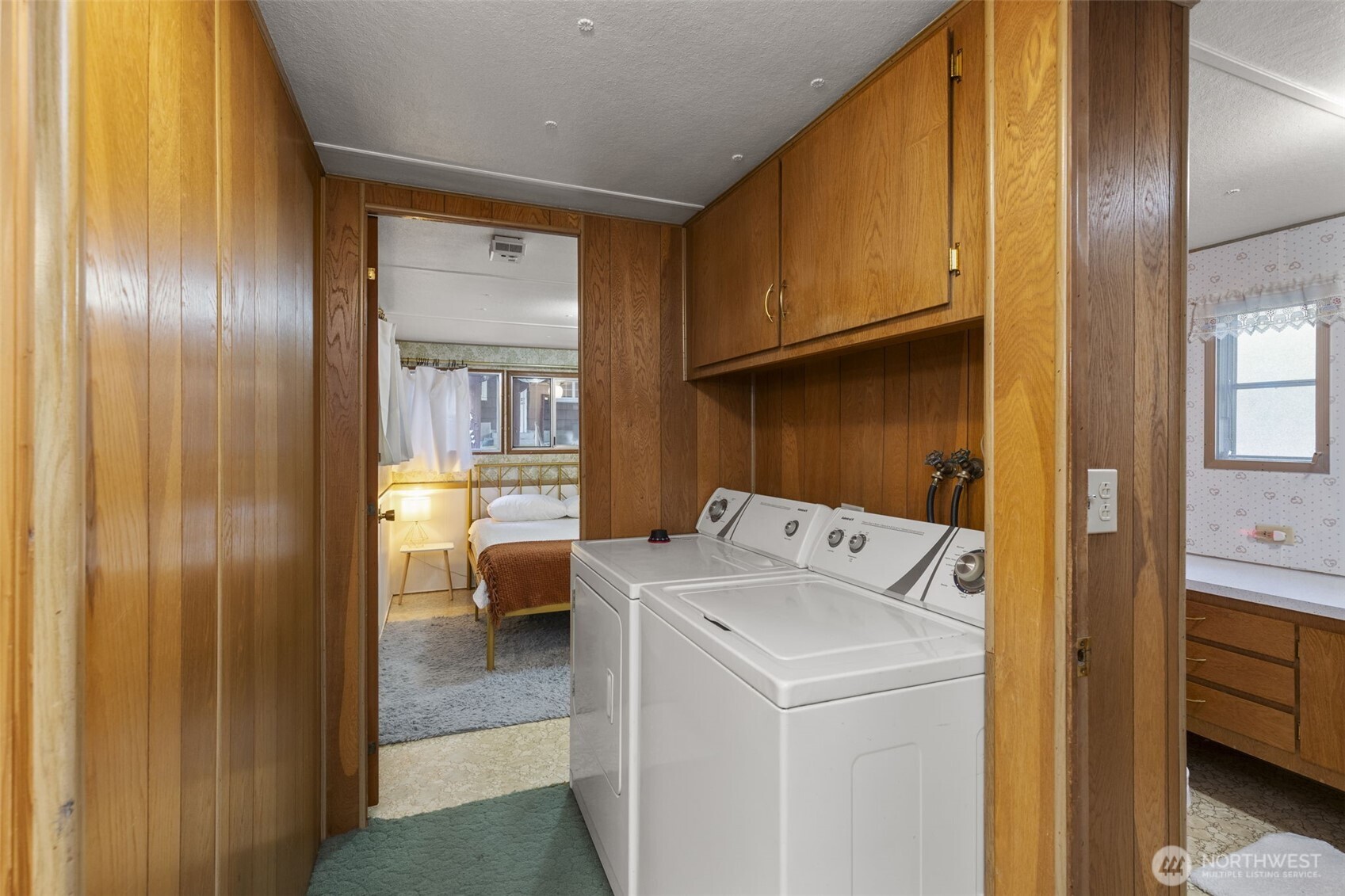 8491 Illahee Road Northeast Bremerton, WA 98311 - Photo 26 of 36 a view of washer and dryer with kitchen in the background