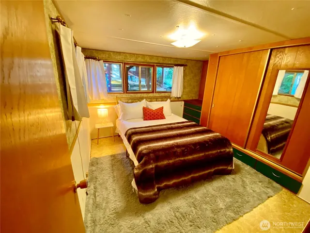 a large bedroom with a bed and large windows